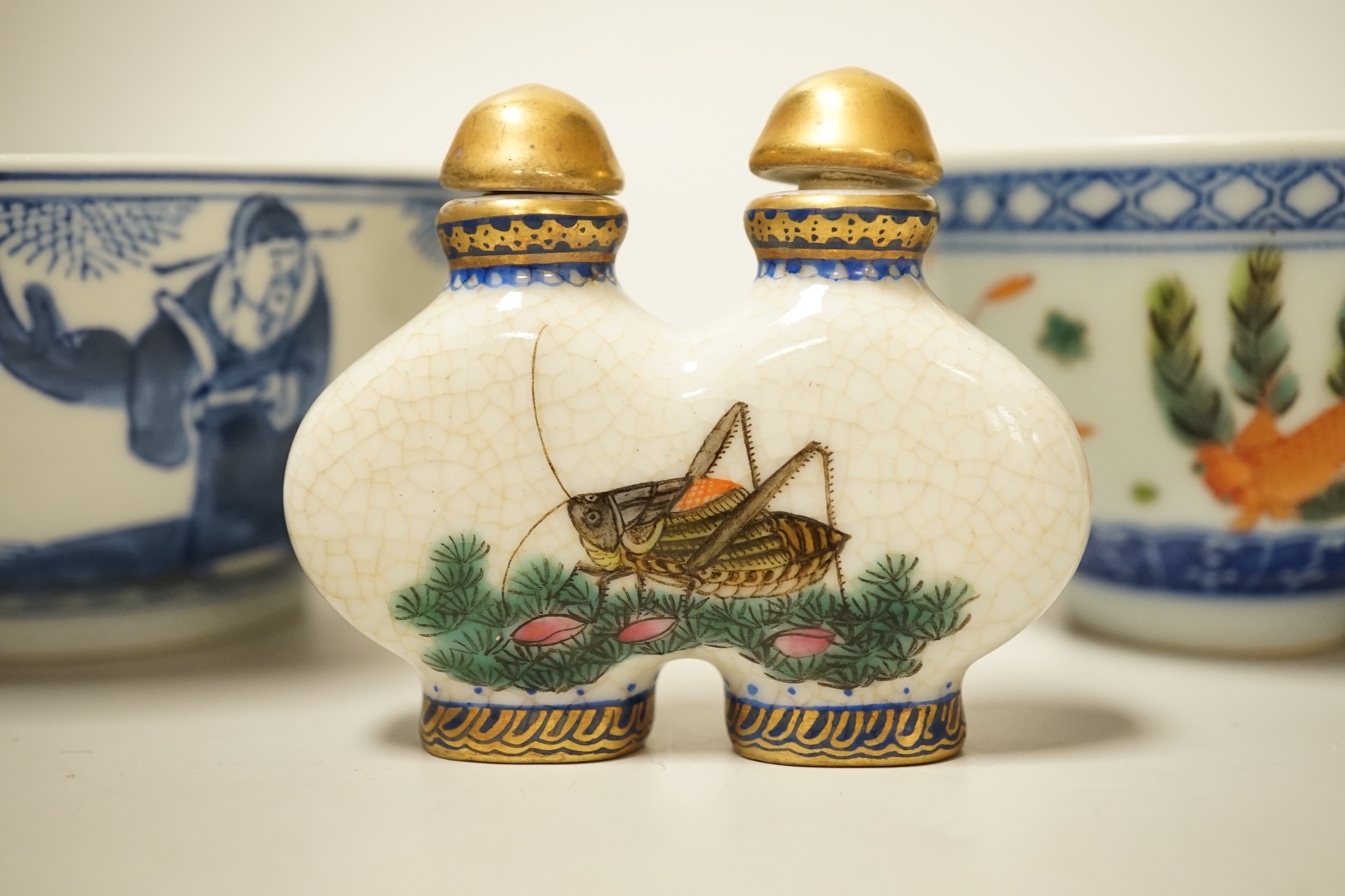 A 19th century Chinese blue and white bowl, an enamelled goldfish cup and two snuff bottles